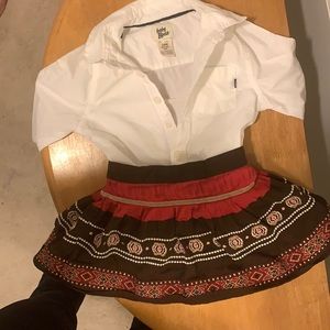 White baby Bgosh shirt with multi color baby gap skirt.